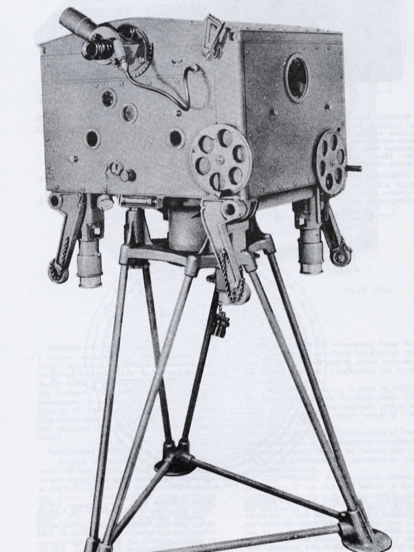 A black and white photograph from a 1944 army manual: a large metal box on a tall three-legged stand, with telescopes, round dials and handwheels on its sides. A heading reads Director, A.A., M5, M5A1 and M5A2.